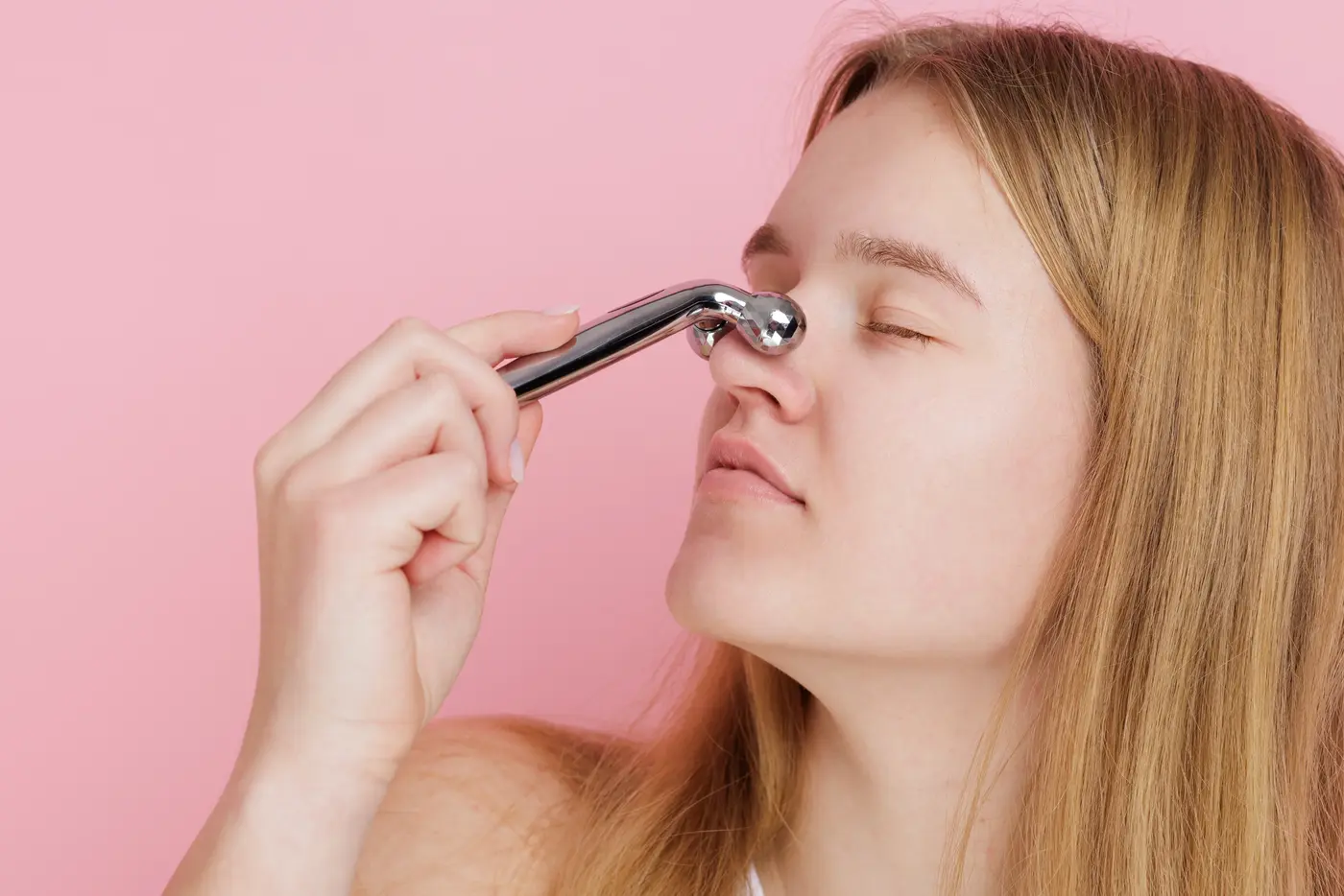 Teen girl massaging nose bridge for sinus relief